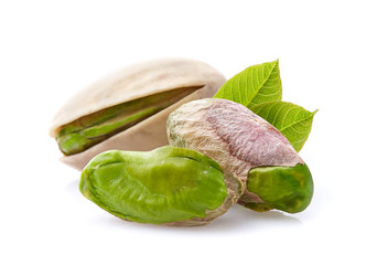 Wall Mural - Pistachio nuts with leaves on white background