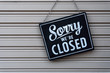 © Maderla - Sorry we're closed sign. grunge image hanging on a  metal door.