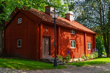 Old Red Cottage In A Park