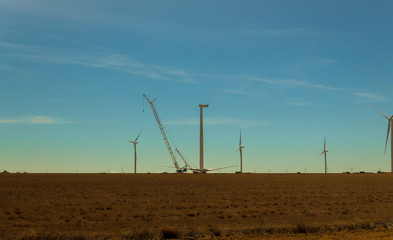 Electric wind turbine windmill installation wind turbine with blue sky