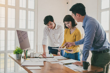 Wall Mural - group of young asian creative people. mobile application designers and website designers brainstorm 