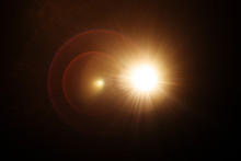 Easy To Add Lens Flare Effects For Overlay Designs Or Screen Blending Mode To Make High-quality Images. Abstract Sun Burst, Digital Flare, Iridescent Glare Over Black Background.