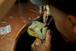 © Westend61 - Man repairing a ring with a missing diamond