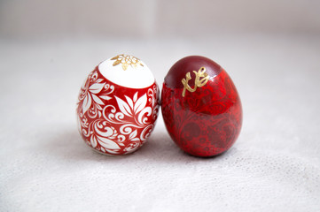 two red Easter eggs on a white background
