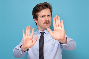 Wall Mural - man with mustache moving away hands palms showing refusal and denial gesture