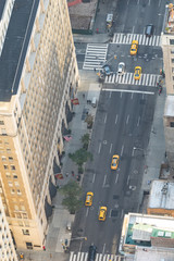 Wall Mural - Yellow cabs traffic along a major Manhattan Avenue, overhead aerial view, New York City, USA