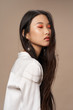 Leinwanddruck Bild - Pretty woman of Asian appearance makeup luxury charm beige background