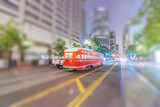Fototapeta  - Red tram speeding up in Market Street at night, San Francisco.