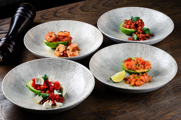 Wall Mural - set of dishes with avocado, tartare and shrimp on a half avocado