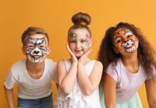 Funny Children With Face Painting On Color Background