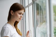 © SHOTPRIME STUDIO - Woman looking out the window at home interior vacation dreamy look