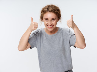 Cheerful woman in glasses studio gesture finger smile