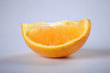 Fototapeta Kuchnia - Orange slices on a white table