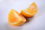 Fototapeta Kuchnia - Orange slices on a white table