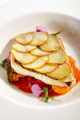 Canvas Print - Fried flounder fillet on baked potato slices