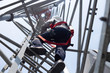 Leinwandbild Motiv Engineer wear safety equipment climb high telecom tower for maintenance 5G network working 