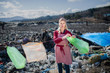 Woman on landfill, consumerism versus plastic pollution concept.
