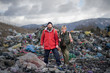 © Halfpoint - Man and woman hikers on landfill, environmental concept.