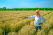 © PRASANNAPIX - young indian farmer at golden wheat field