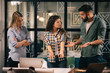© JustLife - Successful teamwork. Business people in office.