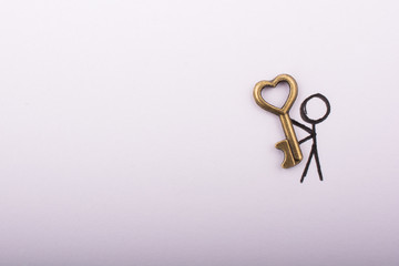 Wall Mural - Man carrying a  retro style heart shaped key as love concept