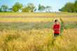 © PRASANNAPIX - young indian child playing at wheat field, Rural india