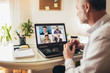 Man working from home having online group videoconference on laptop