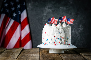 American national holidays concept - 4th of July, Memorial Day, Labour Day. Layered spounge cake in USA flag colours, rustic background, copy space