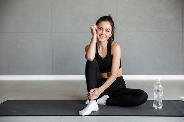 Sticker - Photo of pleased woman smiling while sitting with water bottle