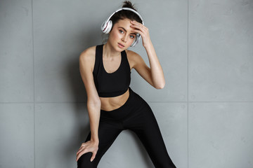 Poster - Photo of nice seductive woman in sportswear using headphones