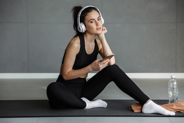 Poster - Photo of nice seductive woman using headphones and mobile phone