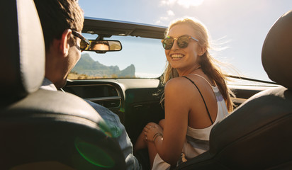 Wall Mural - Couple traveling in a cabriolet car