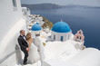 © hreniuca - Wedding couple up the stairs of the streets of Santorini.