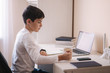 © Aleksandr - Schoolboy study at desk in his room. Boy use laptop for lessons. Drink tea. Books and tablet on the table. Study home during qurantine