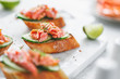 Toasts with fresh cucumber and smoked salmon served with lime shavings.