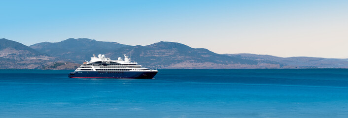 Wall Mural - Side view of small cruise ship on the Aegean Sea. Panorama.