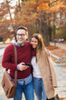 © Jelena - Couple in the park enjoying autumn season.