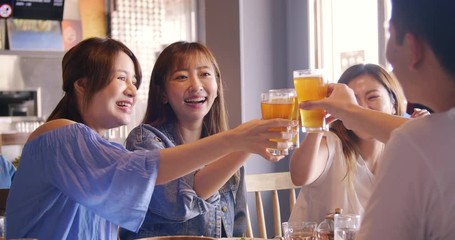 Wall Mural - happy young group dining and drinking beer at restaurant