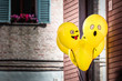 Yellow Emoji balloons floating at a street party in Senigallia, Le Marche, Italy