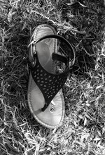 High Angle View Of Abandoned Footwear Sandal On Grassy Field