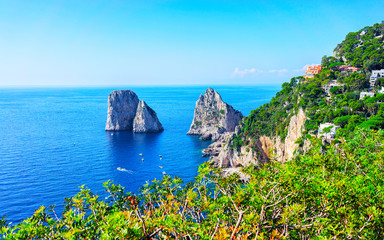 Wall Mural - Boats at Faraglioni cliffs and Tyrrhenian Sea in Capri Island reflex