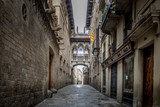 Fototapeta Uliczki - Barcelona, Catalonia / Spain: 04 09 2020: empty streets in the Bisbe street, in the Gothic Quarter in the city of Barcelona during the covid-19 coronavirus pandemic