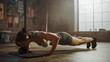 Strong and Fit Athletic Woman in Sport Top and Shorts is Doing Push Up Exercises in a Loft Style Industrial Gym with Motivational Posters. It's Part of Her Cross Fitness Training Workout. Warm Light.