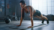 Strong and Fit Athletic Woman in Sport Top and Shorts is Doing Push Up Exercises in a Loft Style Industrial Gym with Motivational Posters. It's Part of Her Cross Fitness Training Workout. 
