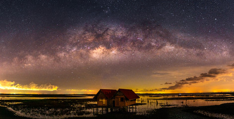 Wall Mural - the milky way (bridge over thale noi and twin houses, phatthalung province, thailand) on a clear cle