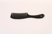 A Black Comb On An All White Back Ground
