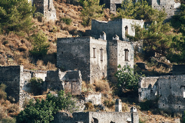 The abandoned Greek village of Kayakoy, Fethiye, Turkey. Ghost Town Kayakoy. Turkey, evening sun. Ancient abandoned buildings of rock and stone.