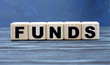 © Zhanna - concept word FUNDS on wooden cubes on a gray background