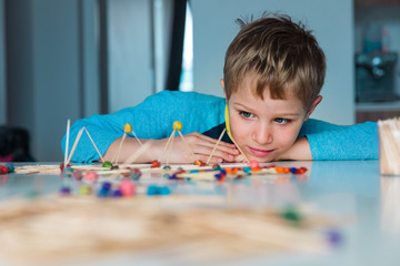 Wall Mural - cute boy making geometric shapes with sticks, engineering and STEM