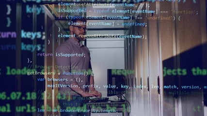 Wall Mural - double image of the engineer working on the laptop and the computer code